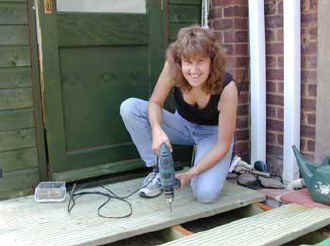 Fixing the deck boards with screw gun in this instance