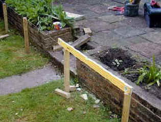 A string line, temporary pegs and a spirit level to determine the lay of the deck sub frame