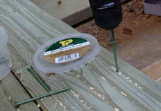 Deck screws being driven home with power screwdriver