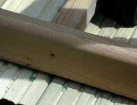 Decking spindles fixed to bottom rail of railings