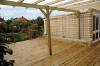 Pergola, deck, and trellis all match in - being constructed of softwood timber