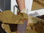 Mortar being firmed onto the brick butt
